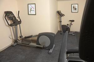a gym with two exercise bikes and two tread machines at La Riva Hotel in Aqaba