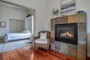 a living room with a fireplace and a bed at Sea Depoe Bay in Depoe Bay