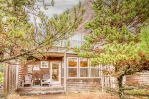 a house with a table and chairs on a porch at Beach Break in Pacific City