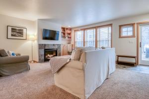 a living room with a couch and a fireplace at Beach Break in Pacific City