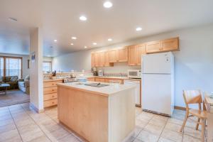 a kitchen with a white refrigerator and a table at Beach Break in Pacific City
