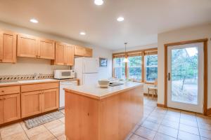 a kitchen with wooden cabinets and a white refrigerator at Beach Break in Pacific City