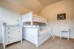 a bedroom with a bunk bed and a ladder at Beach Break in Pacific City