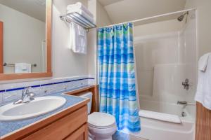a bathroom with a sink and a toilet and a shower at Beach Break in Pacific City +34 photos