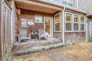 a house with two chairs and a table on a porch at Beach Break in Pacific City