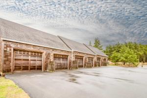 a barn with two garage doors and a cloudy sky at Beach Break in Pacific City