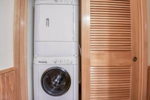 a laundry room with a washer and dryer next to a door at Beach Break in Pacific City