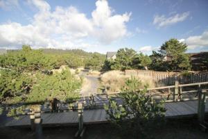 a view of a garden with trees and a bridge at Beach Break in Pacific City