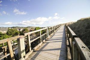 a wooden bridge over a hill with a view at Beach Break in Pacific City