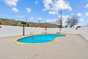 a swimming pool in front of a white fence at Quality Inn & Suites Okanogan - Omak in Okanogan