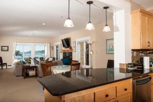 a kitchen and living room with a view of the ocean at Lighthouse View at Shoreline Ridge in Newport