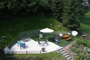 an overhead view of a patio with a table and an umbrella at Garni Panoramik in Ortisei