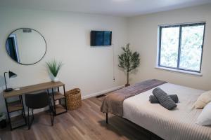 a bedroom with a bed and a desk and a mirror at 5-BR Serene Retreat Near CLE* Dogs welcome! in Berea