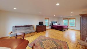 a bedroom with a bed and a desk and a table at Om Home in Lincoln Beach