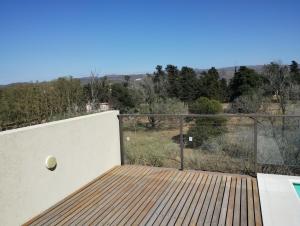 a deck with a tennis ball on top of it at Moderno Departamento en Alta Gracia in Alta Gracia
