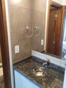 a bathroom with a sink and a mirror at Moderno Departamento en Alta Gracia in Alta Gracia