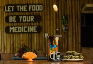 a table with a cup of food and a pitcher at Cecropia Ecolodge in Fortuna