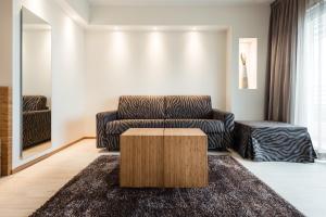 a living room with a couch and a coffee table at Laguna Park Hotel 4Superior in Bibione