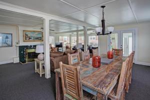 a dining room with a table and a couch at Sand Dollar in Seaside