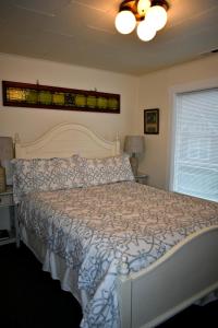 a bedroom with a bed with a white bedspread at Sand Dollar in Seaside