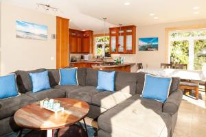 a living room with a couch and a table at Schooner Creek Retreat in Lincoln City