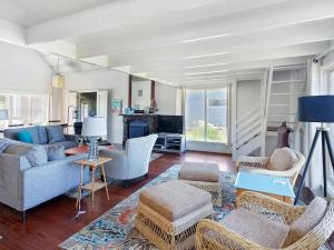 a living room with a blue couch and chairs at Seaside Cove Vue in Seaside