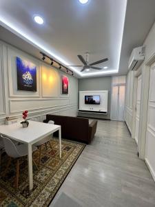 a living room with a table and a couch at Ali Homestay Sungai Petani in Sungai Petani