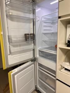 an empty refrigerator with its door open in a kitchen at SurfingStay in Yangyang +31 photos