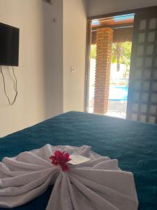 a white towel on a bed in a room at Home Beach Mar Conforto Self-Hosted in Aquiraz