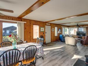 a dining room with a table and chairs and a living room at Steve's Getaway in Seaside