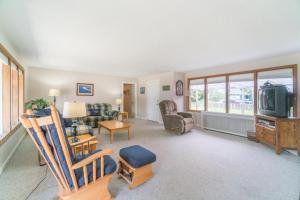 a living room with a couch and a tv at Surfers Cove in Seaside