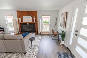 a living room with a couch and a fireplace at Cozy Cove Cottage in Seaside