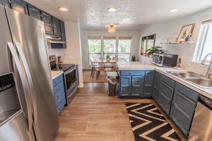 a kitchen with blue cabinets and a counter top at Cozy Cove Cottage in Seaside