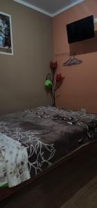 Ένα ή περισσότερα κρεβάτια σε δωμάτιο στο Hostal El Ángel