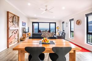 a living room with a table and chairs at Whale Watcher 2 in Coles Bay
