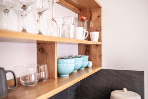 a shelf filled with glasses and vases at Whale Watcher 2 in Coles Bay