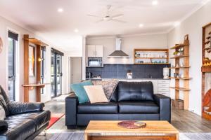 a living room with a couch and a table at Whale Watcher 2 in Coles Bay