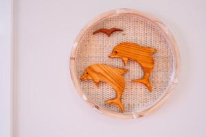 a basket with two wooden horses and birds on it at Whale Watcher 2 in Coles Bay