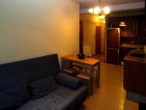 a living room with a couch and a table at Pensión Plaza del Ayuntamiento in Cangas de Onís