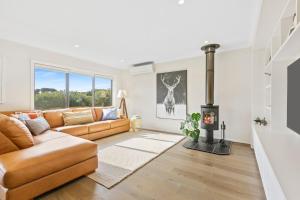 a living room with a couch and a fireplace at Cape Retreat in Cape Schanck