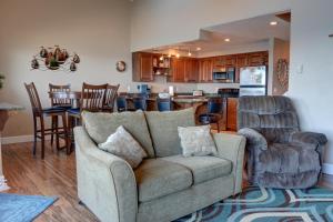 a living room with a couch and a kitchen at Bay Echo in Depoe Bay