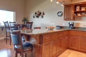 a kitchen with a large island with wooden cabinets at Bay Echo in Depoe Bay +120 photos