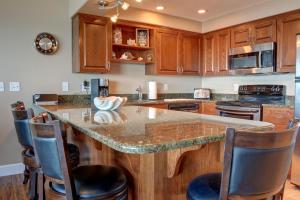 a kitchen with a large island with bar stools at Bay Echo in Depoe Bay