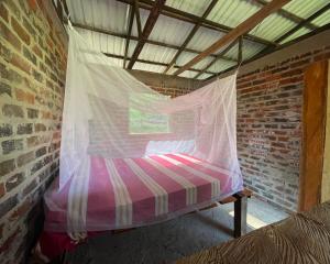 Ένα ή περισσότερα κρεβάτια σε δωμάτιο στο Villa Medici Macarena, finca eco-turistica