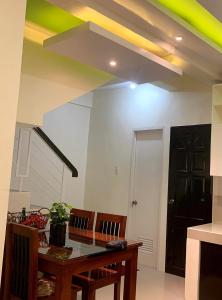 a room with a table and chairs and a ceiling at The Ideal Place in Cauayan city in Cauayan City