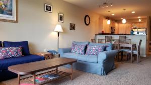 a living room with a blue couch and a table at Riverview Retreat in Seaside