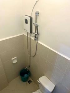 a bathroom with a shower with a toilet and a bucket at The Ideal Place in Cauayan city in Cauayan City