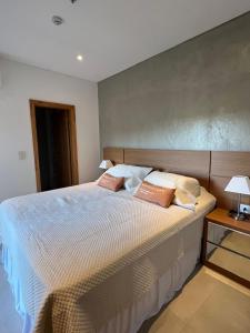 a bedroom with a bed with two pillows on it at Gomez de castro apartments in Asunción