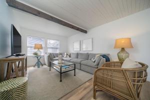 a living room with a couch and a table at Hydrangea House in Seaside