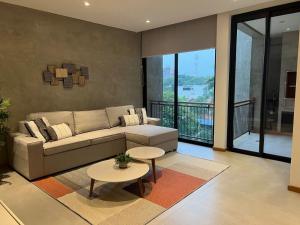 a living room with a couch and a table at Gomez de castro apartments in Asuncion